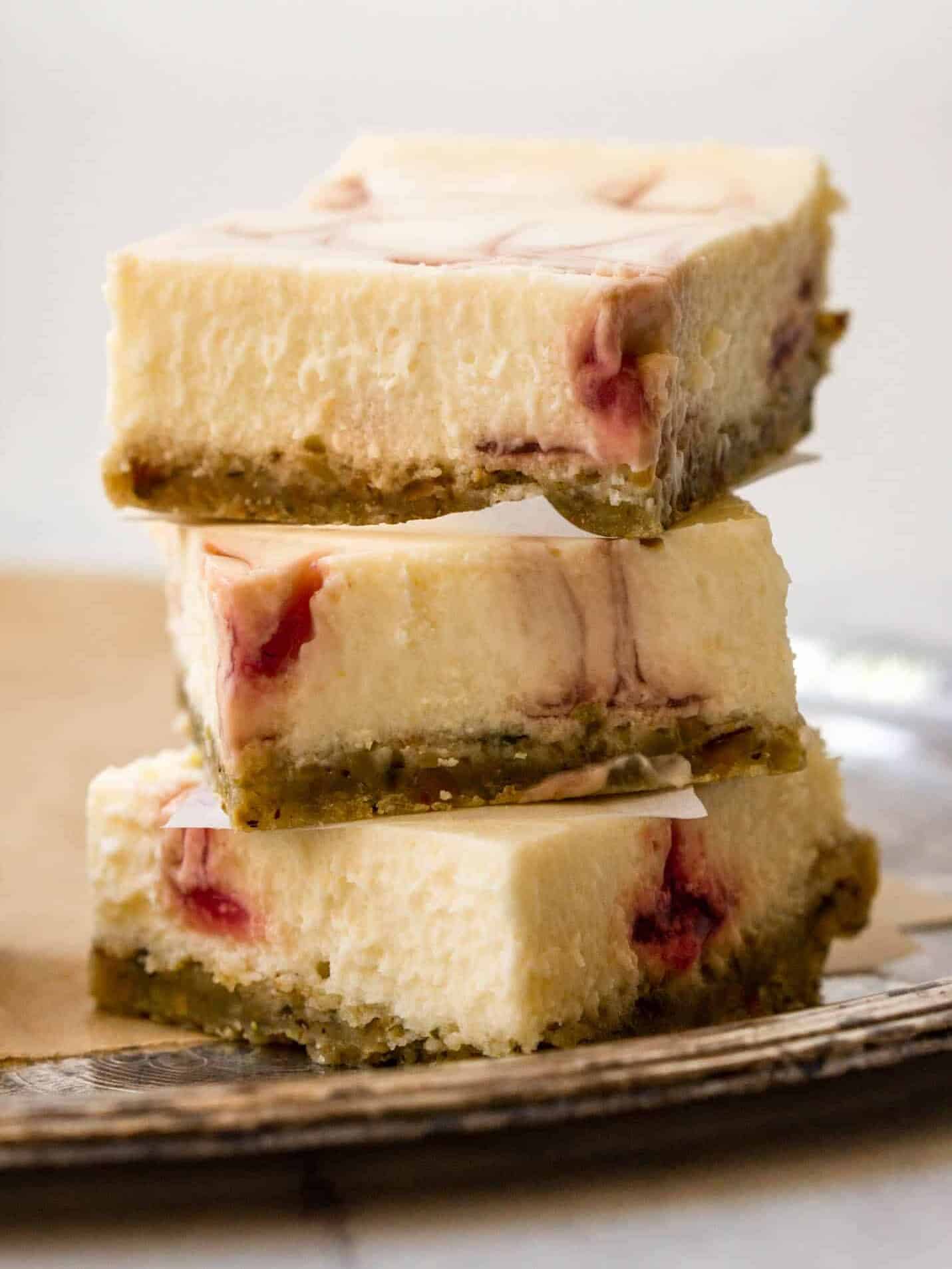 Image of a stack of strawberry pistachio cheesecake bars