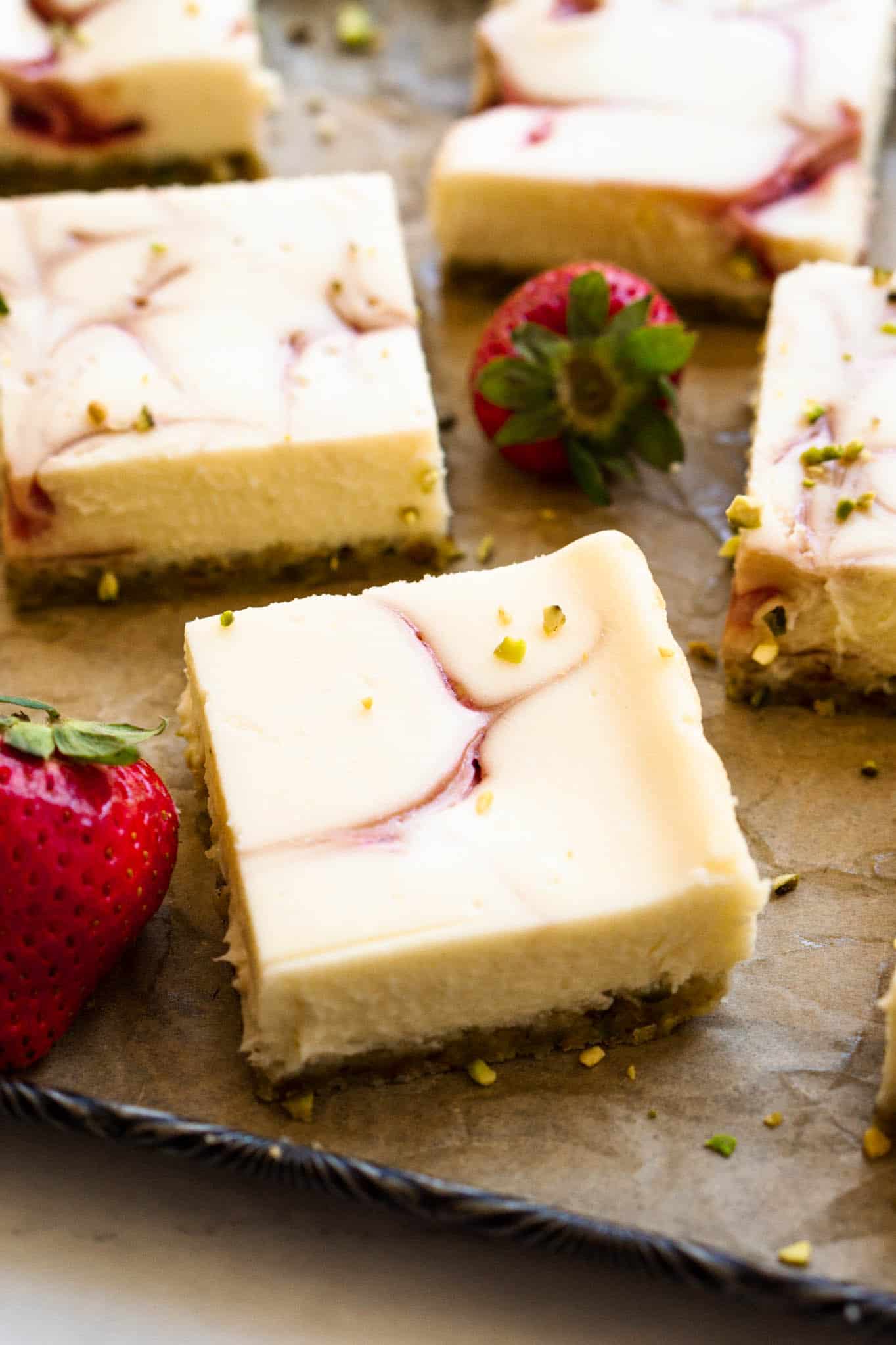 Straight on picture of strawberry pistachio cheesecake bars