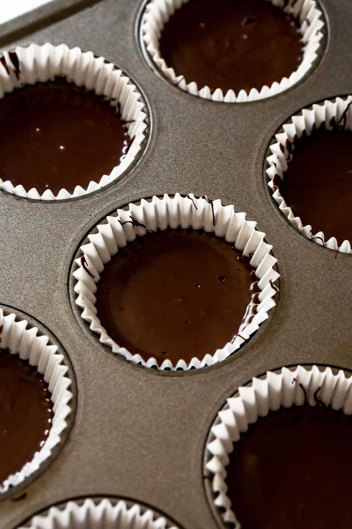 Process image of almond butter cups being assembled