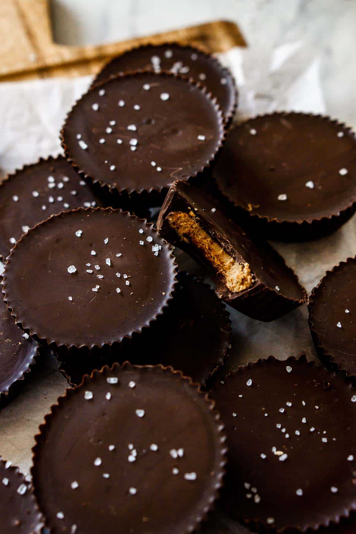 Chocolate almond butter cups with bite taken out of one.
